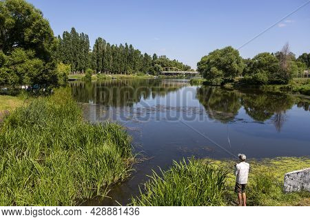 Belgorod, Russia - July 08, 2021: Fisherman Catches The Fish In The Vezelka River In Victory Park In