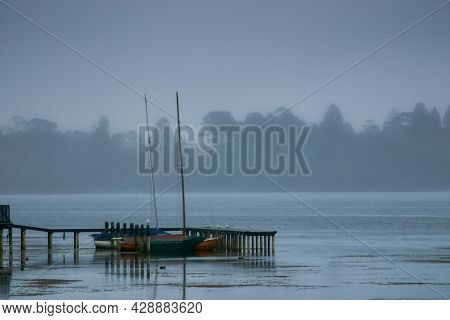A Cold Foggy Morning On The Shore Of Lake Wendouree In Ballarat, Victoria, Australia. Small Sail Boa