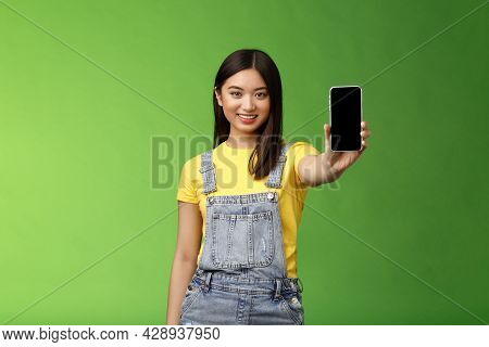 Self-assured Attractive Asian Brunette Show Smartphone Screen, Introduce New Telephone Appllication,