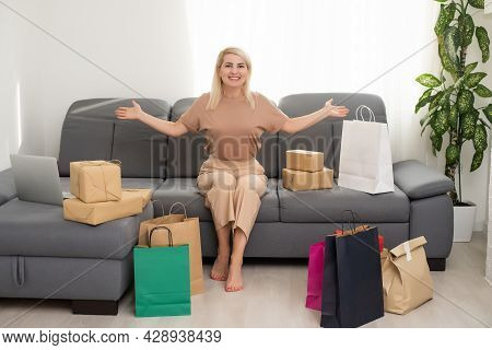 Smiling Satisfied Young Woman Customer Sit On Sofa Unpack Package Open Parcel, Happy Woman Consumer 
