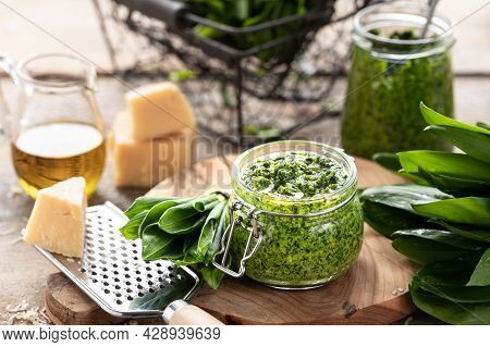 Wild Leek Pesto With Olive Oil And Parmesan Cheese In A Glass Jar On A Wooden Table. Useful Properti