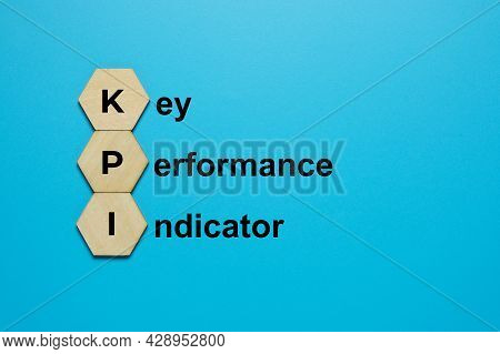 A Picture Of Kpi On Hexagon Wood And The Word Key Performane Indicator Word. Measurement For Achieve