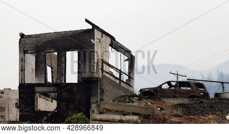 Fire Debris Of Houses In A Small Town With Smoke In Sky. Caused By Forest Wildfires In Lytton, Briti