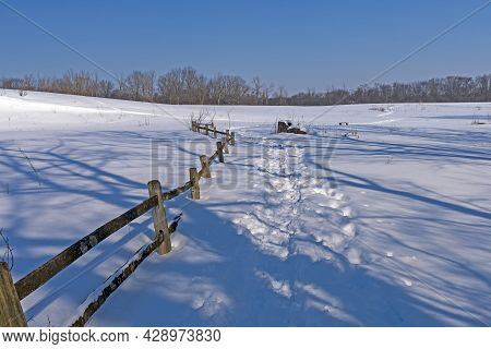 Rustic Fence Along A Snowy Trail In The Crabtree Nature Center In Illinois
