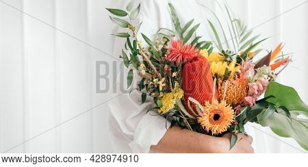 Woman holding a colorful tropical bouquet