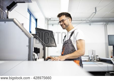 An Experienced Mechatronics Engineer Checking Automated Robotic System In Factory Test Room.