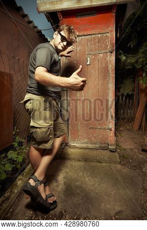 Man Leaving Wooden Toilet Latrine On Summer Cottage