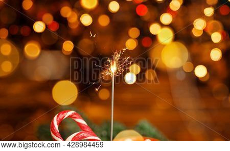 Glittering Burning Sparkler. Christmas Lights. Burning Sparkler With Bokeh Dark Background. Sparkler