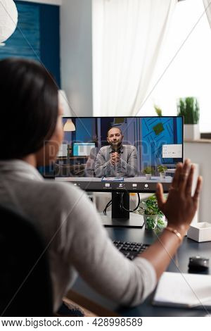African American Woman Greeting Remote Entrepreneur Using Laptop Computer Webcam During Online Video