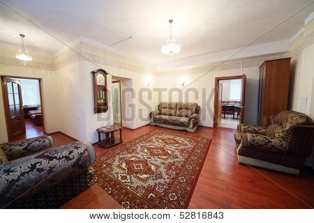Living room with a sofas, a wall clock and a carpet on the floor