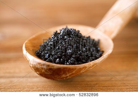 Hawaiian Black lava sea salt in rustic wooden spoon