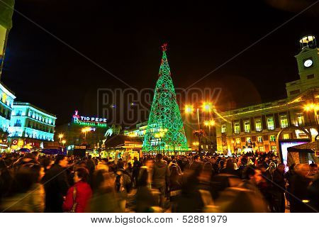 People Have Fun In Christmas Time Passing The Famous Illuminated Christmas Tree At Puerta Del Sol