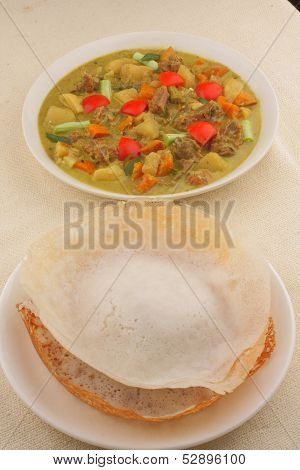 Appam with mutton stew