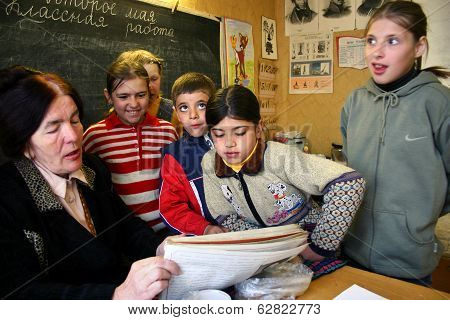 School Class In The Russian Village School Children Pupils Gathered Around A Schoolteacher.