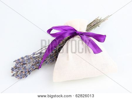 Textile sachet pouch with dried lavender flowers isolated on white