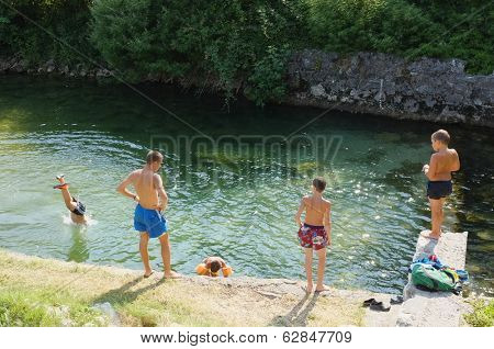 VIRPAZAR, MONTENEGRO - JULY 13: children playing in the clear water of the Orahovo river in Montenegro on 13 July, 2013. 