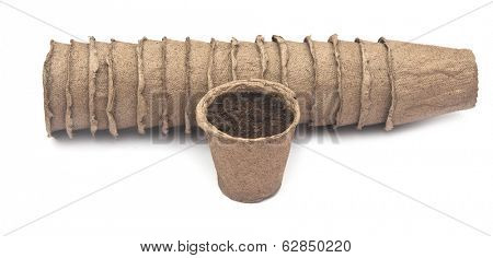 pile peat pots for growing seedlings, isolated on white background 