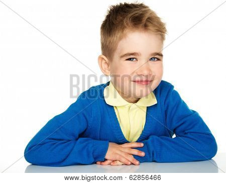 Sly little boy in blue cardigan and yellow shirt 