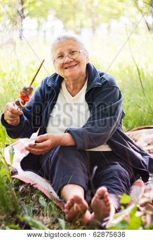 Grandmother with kebab in hand