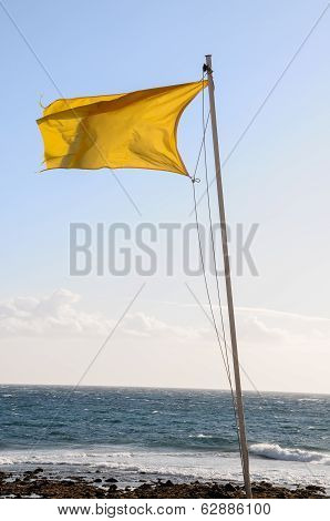 Yellow Festive Flag Waving In The Wind