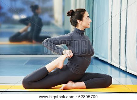 Happy smiling woman at gymnastic physical training fitness exercise in gym
