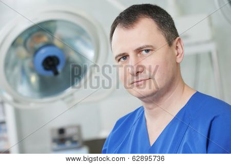 Male surgeon in uniform in front of cardiac surgery operation room at clinic