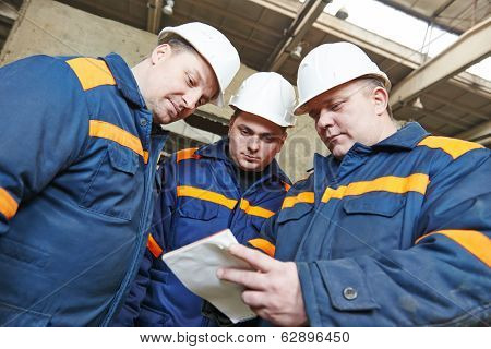 three industrial engineer chief discussing enterprise development in house-building plant