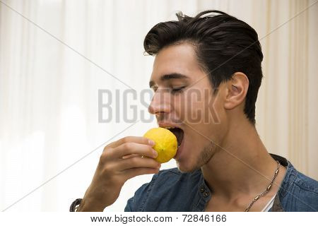 Young Man Biting Lemon