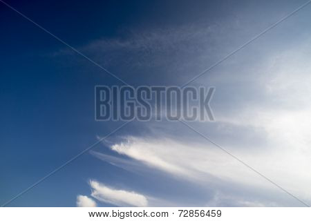 blue sky with white coud trails