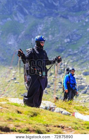 Unidentified paraglider in Balea Lake Fagaras Mountain Romania.