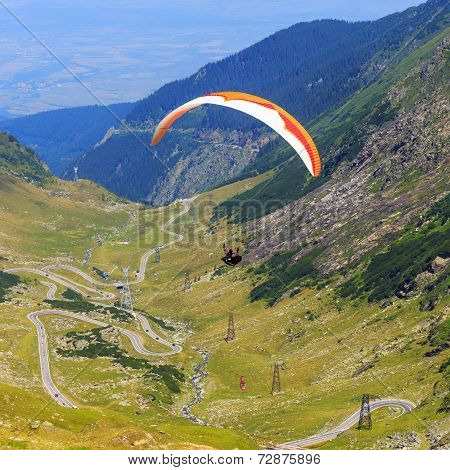 Unidentified paraglider in Balea Lake Fagaras Mountain Romania.