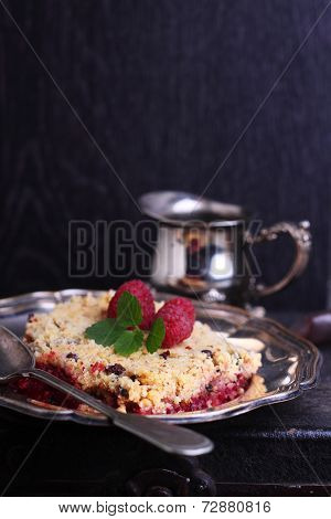 crunchy crumble with raspberry decorated mint leaf