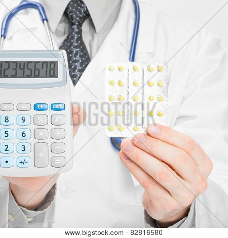 Doctor Holdling Calculator And Pills In His Hands - Heath Care Concept