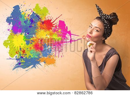 Cute girl blowing bubble spalsh graffiti into wall