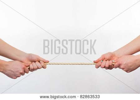 Four hands pulling rope