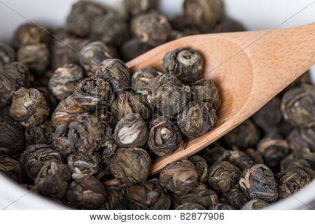 Dry Oolong Tea Leaves In Wooden Spoons