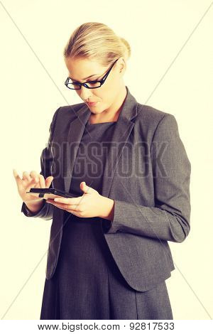 Beautiful businesswoman sending a message