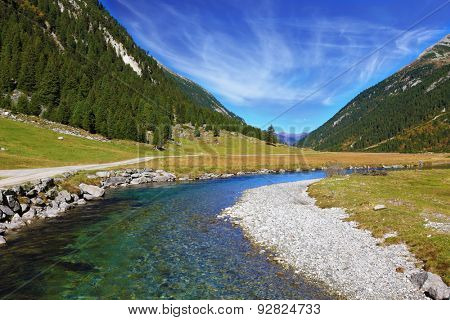 Austrian Alps. Headwaters of the famous Krimml waterfalls. The crystal clear transparent water glows in the midday sun