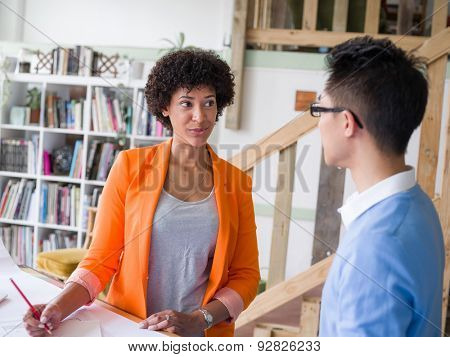 Two desingers working on a project together in office