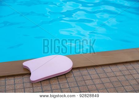 Pink boogie board in swimming pool