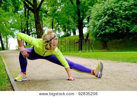 Woman doing stretching exercise before running 