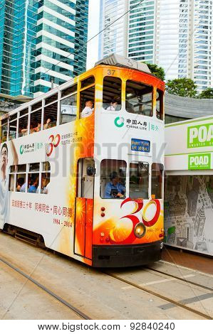 HONG KONG - JUNE 03, 2015: double-decker tram on street of HK. Hong Kong Tramways is a tram system in Hong Kong, being one of the earliest forms of public transport in the metropolis.