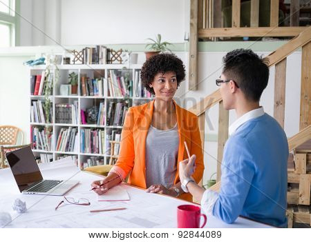 Two desingers working on a project together in office