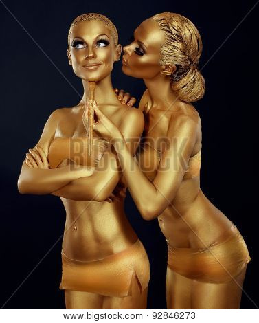 Bodypaint. Two Women Painted Gold. Carnival