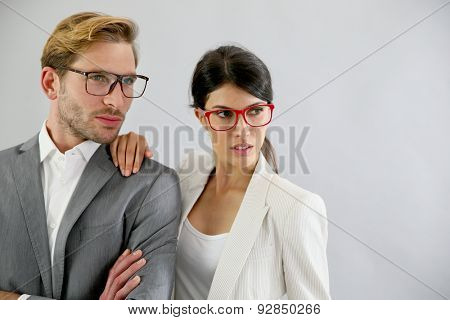Business couple standing on grey background, isolated