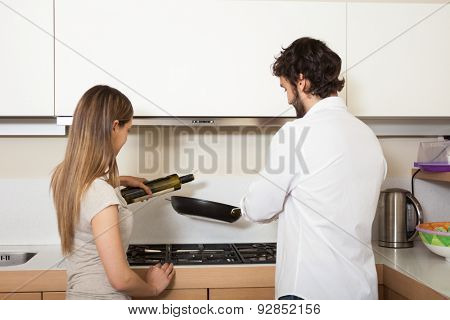 Young couple cooking in their kitchen