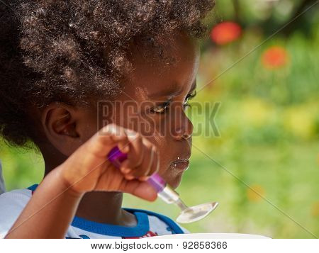 Adorable Black African Baby Eating