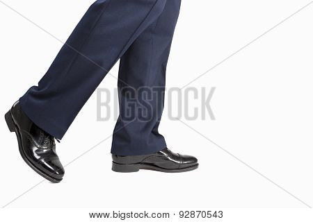 Closeup Of Men's Stylish Semi-brogue Oxford Shoes On A Walking Man. Against White