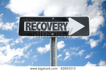 Recovery direction sign with sky background