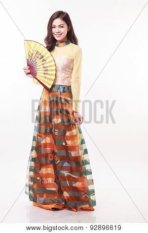 Beautiful Vietnamese Young Woman With Modern Style Ao Dai Holding A Paper Fan On White Background